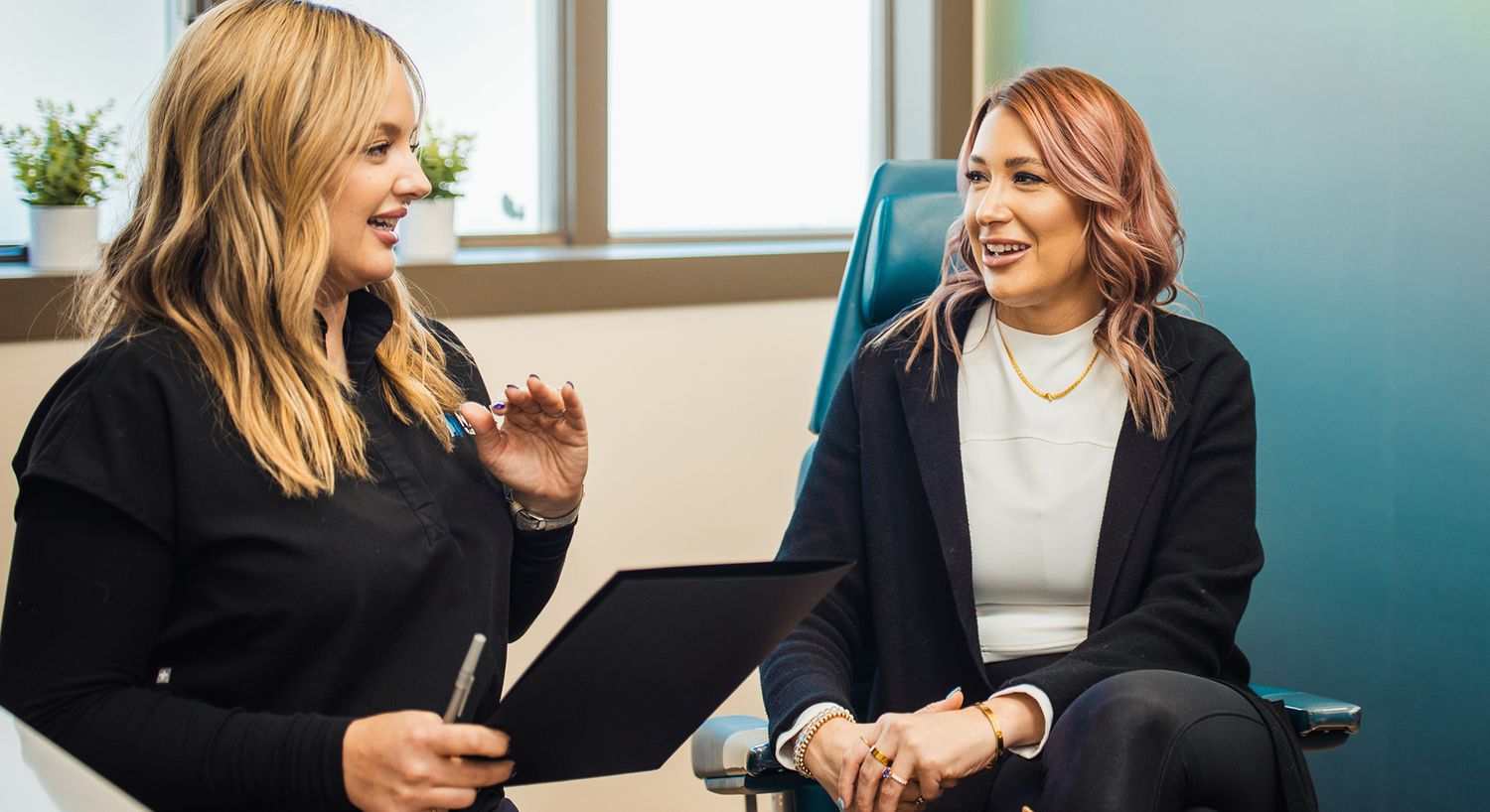 Healthcare consultation between two women.