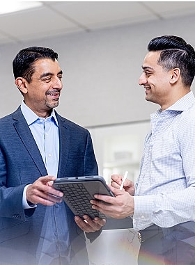 St. Louis facial plastic surgeon Dr. Nayak and  Dr. Kachare speaking together.