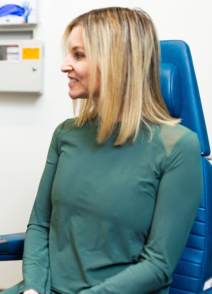 Woman smiling in a medical setting.