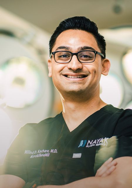 Smiling doctor in medical scrubs.