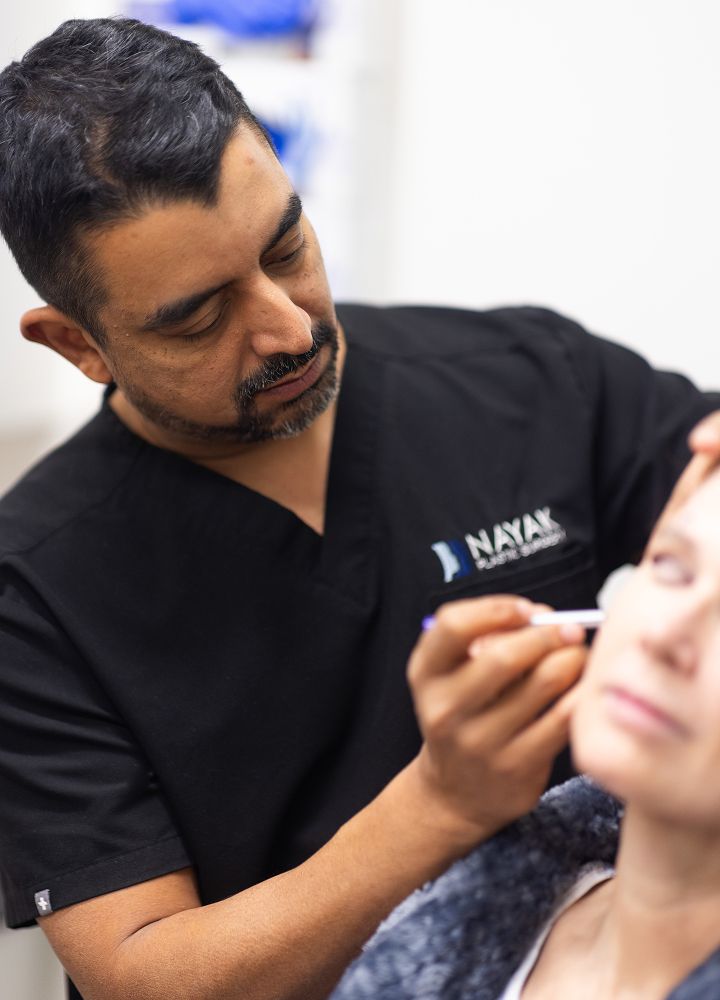 Practitioner administering treatment to a patient.