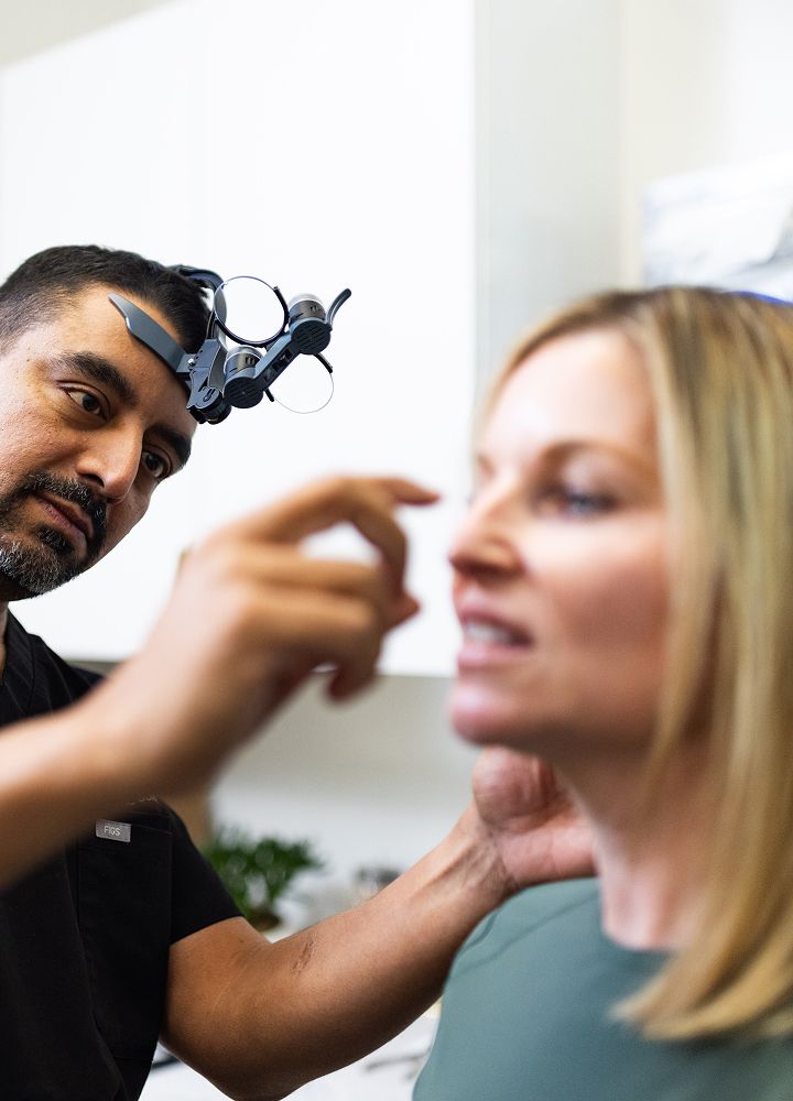 Doctor examining patient with specialized equipment.