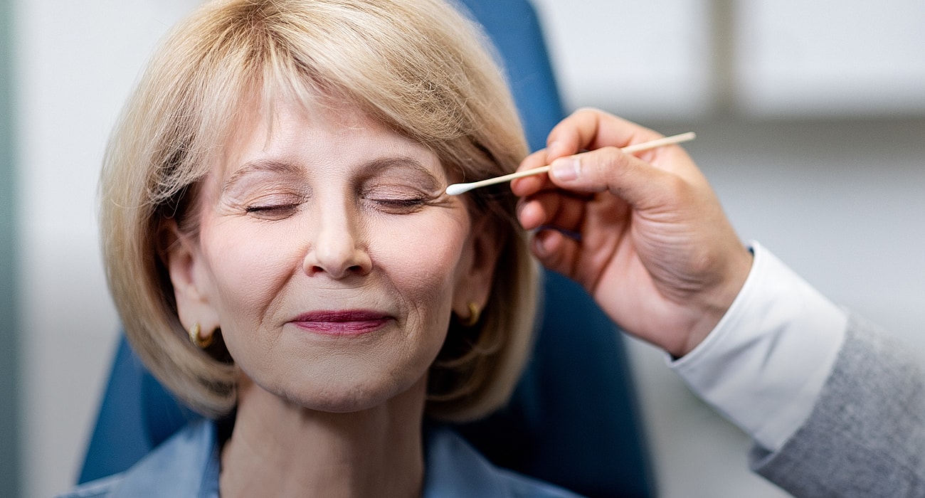 St. Louis facial plastic surgery model  receiving beauty treatment with closed eyes.