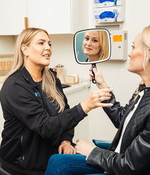 St. Louis facial plastic surgery model during consultation in beauty treatment setting.