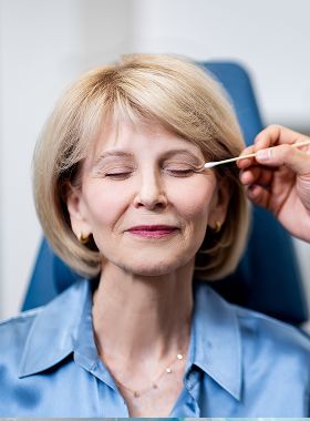 St. Louis facial plastic surgery model receiving cosmetic treatment in a clinic.