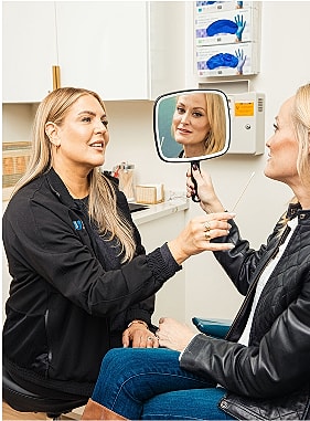 St. Louis facial plastic surgery model during consultation in beauty treatment setting.