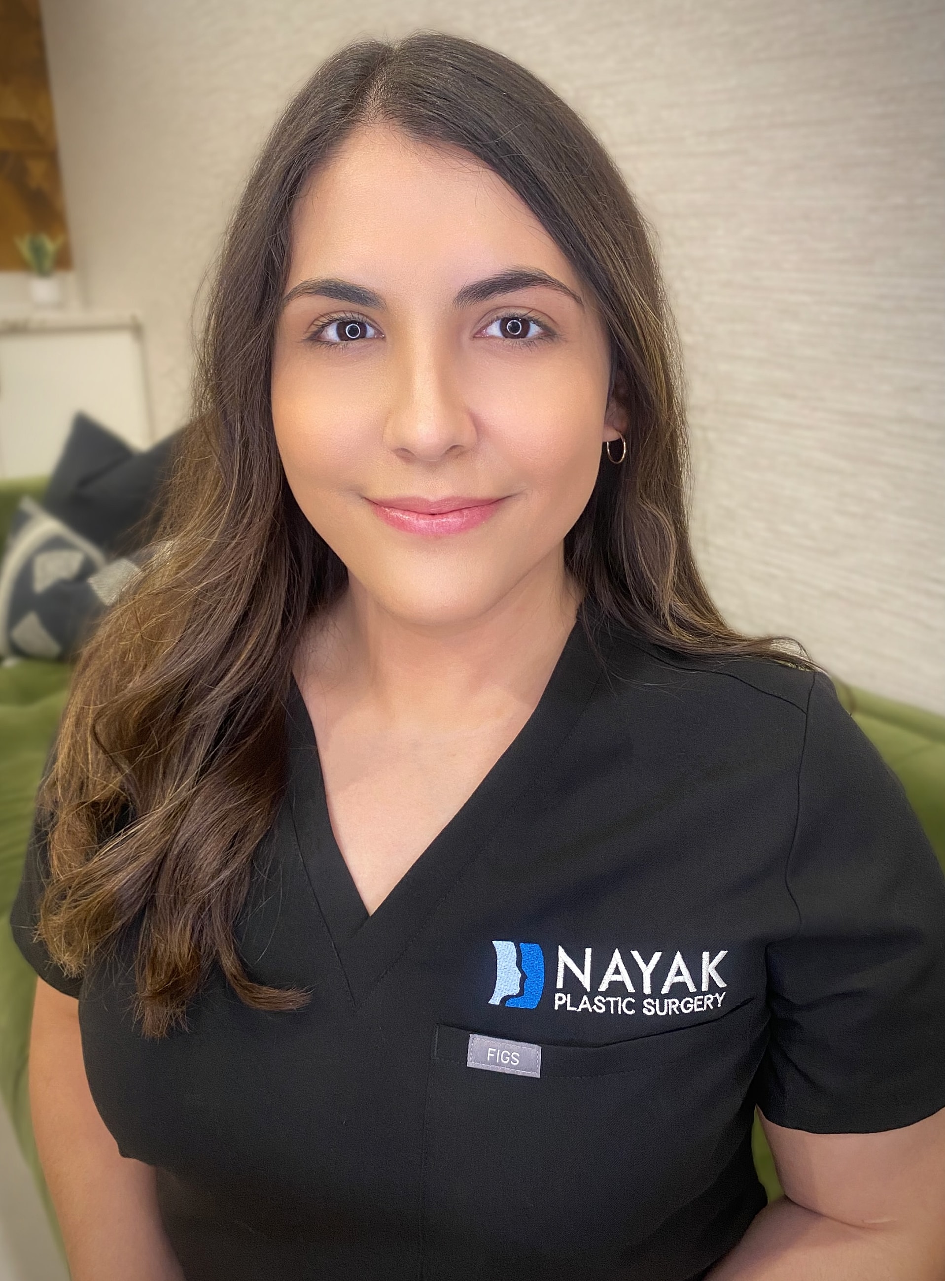 Aleyna Tostado, BSN, RN Smiling professional in medical scrubs.