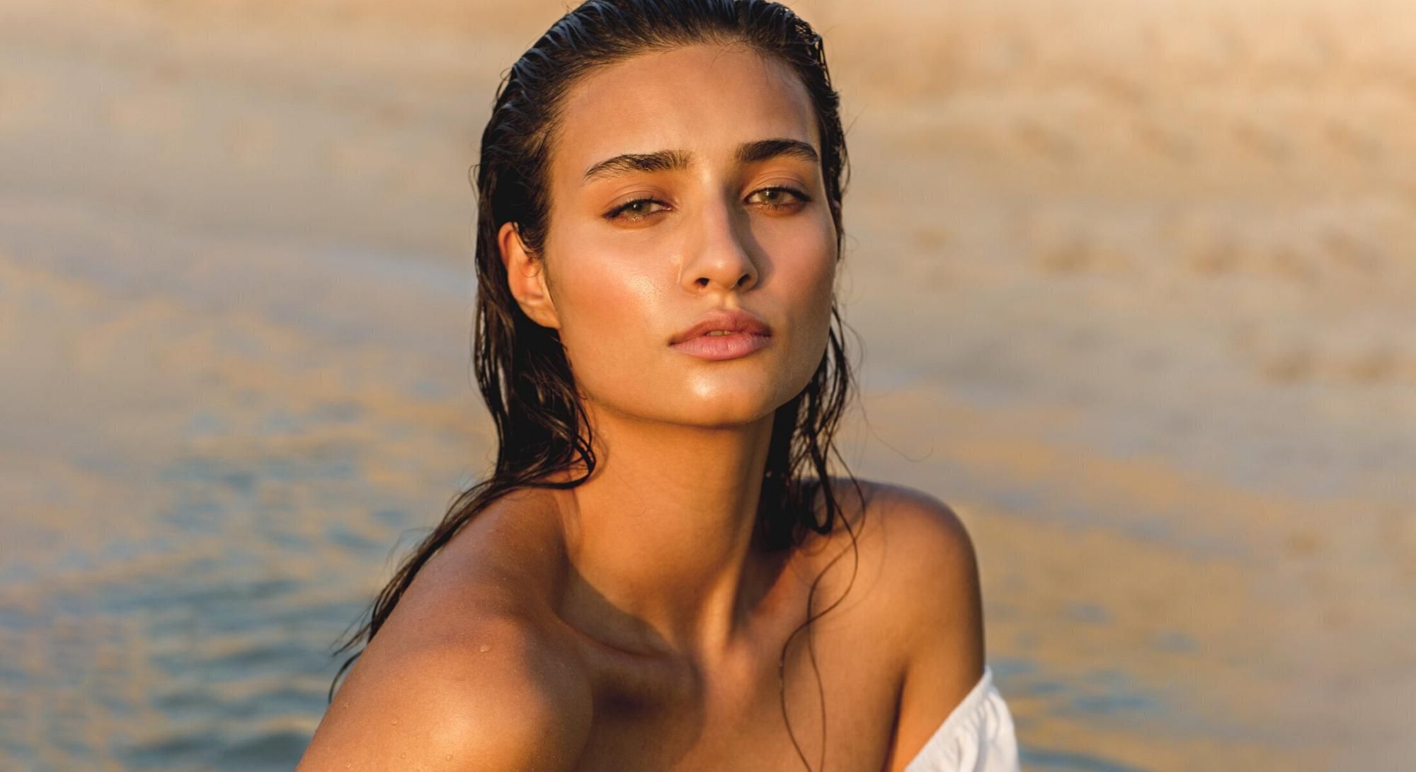 Smiling woman with brown hair and green eyes.