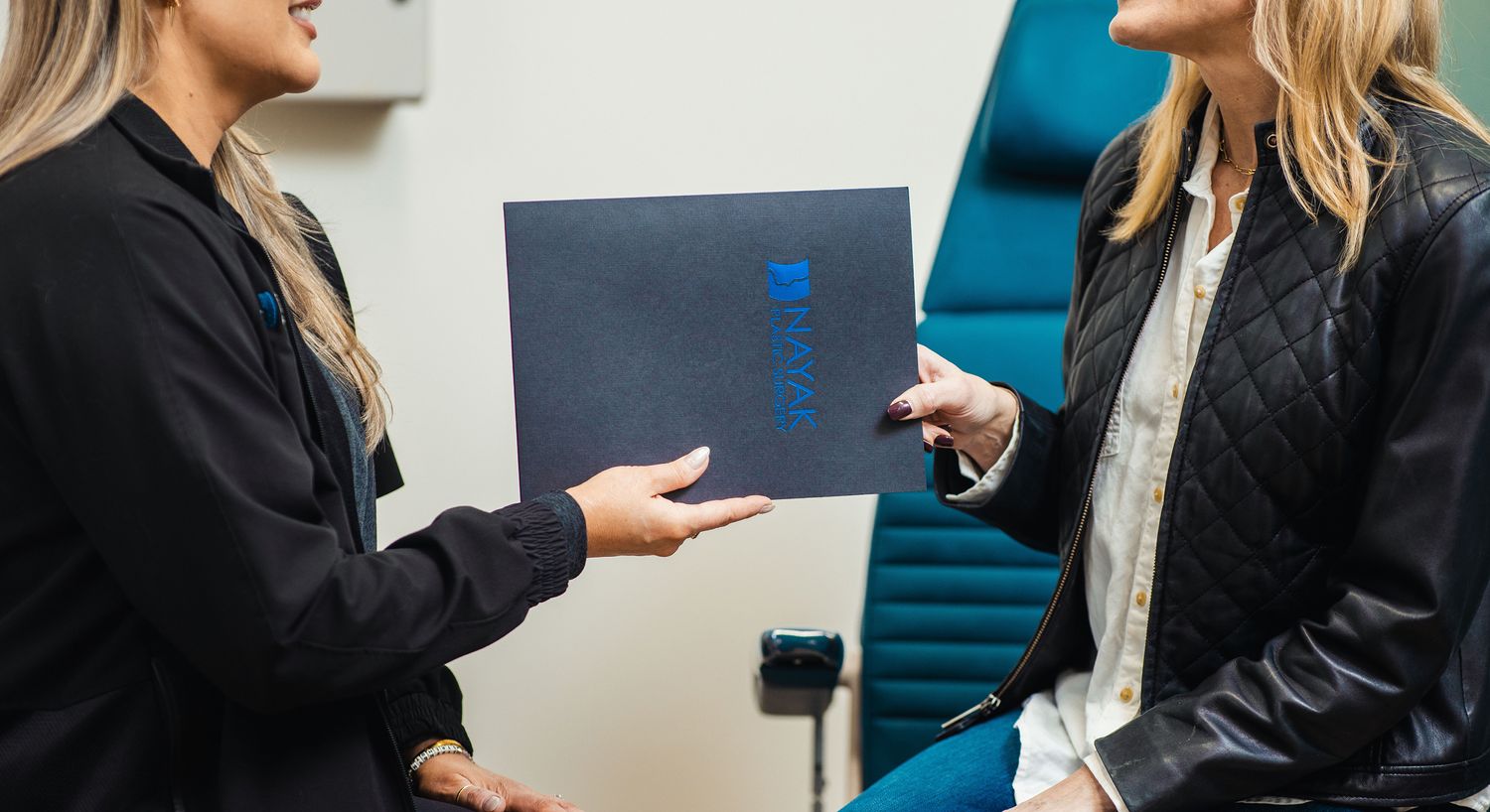 Women discussing a document in a professional setting.