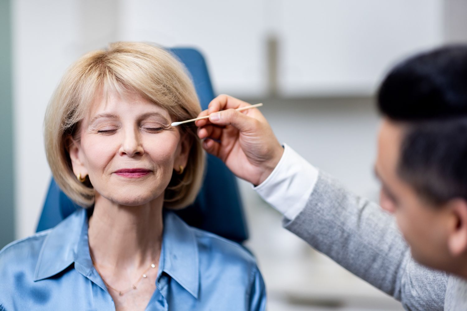 Woman receiving beauty treatment in a clinic.